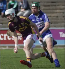  ??  ?? Joe O’Connor gathers possession as Mark Kavanagh (Laois) moves in.