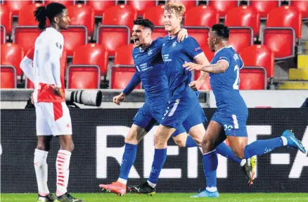  ??  ?? Net gains:
Rangers’ Filip Helander (centre) celebrates with Ianis Hagi (left) and Alfredo Morelos