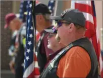  ?? ERIC BONZAR — THE MORNING JOURNAL ?? Pat Law, of North Ridgeville (pictured in the foreground) stands alongside fellow members of the Patriot Guard Riders as they greet those attending the Thomas Mihalis Memorial VFW Post 1079’s memorial service for Elyria native and U.S. Navy Fire...