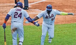  ?? SETH WENIG/ASSOCIATED PRESS ?? The Mets’ Yoenis Céspedes, right, celebrates his homer with Robinson Cano in the seventh inning of New York’s home victory over Atlanta on Friday.