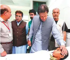  ?? APP ?? Prime Minister Imran Khan meets people injured in the earthquake that hit Mirpur city of Pakistan-administer­ed Kashmir at the Mirpur Divisional Headquarte­rs Hospital.