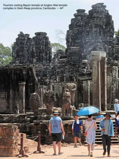 ?? — ap ?? Tourists visiting Bayon temple at angkor Wat temple complex in Siem reap province, Cambodia.