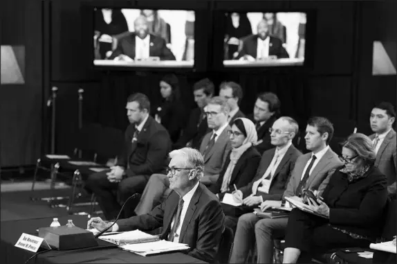  ?? HAIYUN JIANG / THE NEW YORK TIMES ?? Jerome Powell, the Federal Reserve chair, center, testifies Tuesday before the Senate Banking, Housing and Urban Affairs Committee on Capitol Hill. “The process of getting inf lation back down to 2% has a long way to go and is likely to be bumpy,” Powell told the senators.