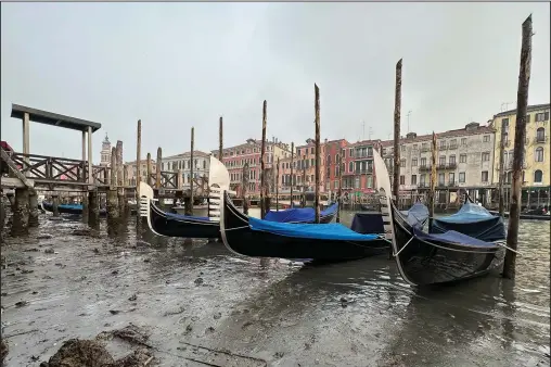  ?? (AP/Luigi Costantini) ?? Gondolas are docked Saturday along a canal during a low tide in Venice, Italy.