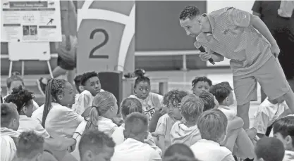  ?? ?? Marquette University men’s head basketball coach Shaka Smart answers questions Monday from Racine youths attending the SC Johnson and 4th Family “STEM and Sport Team Up” camp at the university.