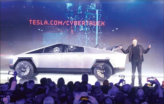  ??  ?? Tesla CEO Elon Musk introduces the Cybertruck at Tesla’s design studio on Nov 21 in Hawthorne, Calif. Musk is taking on the workhorse heavy pickup truck market with his latest electric
vehicle. (AP)