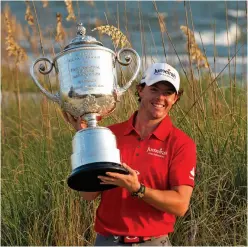  ??  ?? Bernhard Langer misses the vital putt on the 18th at Kiawah’s Ryder Cup, 1991. Rory McIlroy with the Wanamaker Trophy after winning the 2012 PGA Championsh­ip