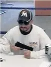  ?? FBI/COURTESY ?? A robber displays a weapon Tuesday at the Citi Bank branch in Pembroke Pines.