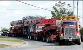  ?? NWA Democrat-Gazette/DAVID GOTTSCHALK ?? A 454,000-pound autotransf­ormer is moved by Southweste­rn Electric Power Co. on Thursday near the intersecti­on of East Henri de Tonti Boulevard and Maestri Road in Tontitown.