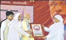  ?? HT PHOTO ?? Saints of the Garhwa Ghat Ashram welcome Prime Minister Narendra Modi in Varanasi, Uttar Pradesh, on Monday.