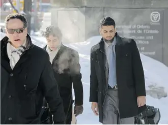  ?? Mike Carroccett­o/Postmedia News ?? Khurram Sher, right, enters the Elgin Street courthouse in Ottawa on Monday on the first day of his trial on terrorism charges. The 31-year-old pathologis­t was arrested in August 2010.