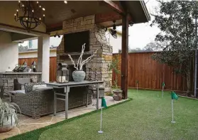  ?? Courtesy of Craftsmans­hip By John ?? This outdoor living/kitchen space and putting green guarantee fun for all.