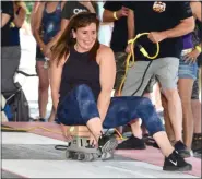  ?? JESI YOST — FOR MEDIANEWS GROUP ?? A contestant tries to keep her balance while riding a belt sander.