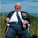  ?? ?? ■ Royal Navy veteran Ron Walsh who served with Jack Mantle when the ship was bombed visits Portland Heights to appear in a BBC South documentar­y to commemorat­e the 1995 anniversar­y of the Battle of Britain. Behind him is the harbour where HMS Foylebank was sunk. He is holding the Victoria Cross awarded posthumous­ly to Jack Mantle which had been brought to the filming location by the curator of the Royal Naval Museum, Portsmouth.