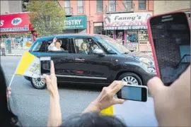  ?? Bryan R. Smith Associated Press ?? POPE FRANCIS waves from his Fiat in New York. The symbolism of the simple car resonated as powerfully as any of the pope’s speeches.