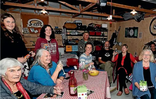  ?? PHOTO: MARTIN DE RUYTER/FAIRFAX NZ ?? Muritai St residents share a Neighbours Day meal in the garage of Bronwyn Shallcrass and Quinton Gately, centre.