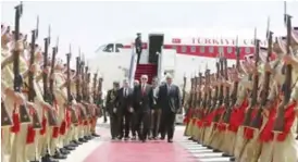  ?? — AP ?? AMMAN: Turkey’s President Recep Tayyip Erdogan, centre, walks during a welcome ceremony at the airport.