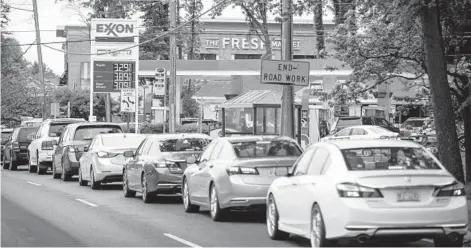  ?? LOGAN CYRUS/GETTY-AFP ?? Motorists line up May 12 at a Charlotte, N.C., gas station after a cyberattac­k of Colonial Pipeline resulted in gas shortages across the Southeast. Colonial paid a $4.3 million ransom in Bitcoin, but over $2 million was recovered.