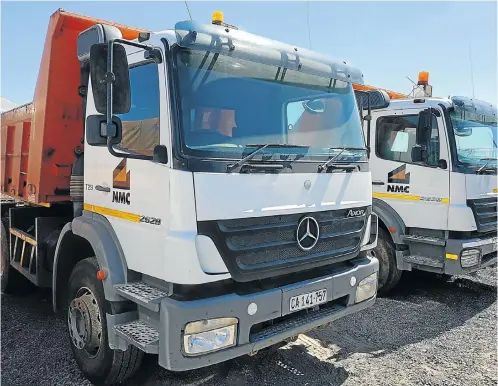  ??  ?? These Mercedes-Benz tippers, above, and several graders, below, will be part of the 800 lots that will be on the block when the movable assets of a constructi­on group and a plant hire company are auctioned off in a massive two-day sale.