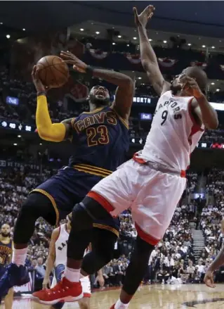  ?? RICK MADONIK/TORONTO STAR ?? LeBron James of the Cavaliers goes to the rim with Serge Ibaka defending late in Friday night’s Game 3 at the Air Canada Centre. James finished with 35 points, eight rebounds and seven assists.