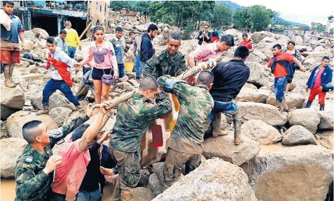  ??  ?? Soldiers rescue landslide victims in Mocoa yesterday, where many residents are still missing. President Juan Manuel Santos has declared a state of emergency