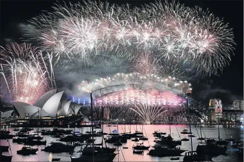  ?? Picture: AFP ?? FLOWERS IN THE SKY: Fireworks light up the sky over Sydney's Opera House, on the left, and Harbour Bridge during New Year celebratio­ns in Sydney on January 1. At midnight tonight, the Foti family are marking two decades as the brains behind Sydney’s...