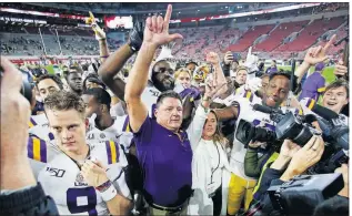  ?? [JOHN BAZEMORE/THE ASSOCIATED PRESS] ?? LSU head coach Ed Orgeron celebrates with his players after defeating Alabama 46-41 last Saturday in Tuscaloosa , Ala.