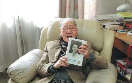  ?? PHOTOS PROVIDED TO CHINA DAILY ?? Xu Yuanchong, prominent translator and professor of Peking University, holds the newly published collection of his diaries kept in the National Southweste­rn Associated University, at his home in Beijing in February.
