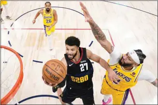  ?? ?? Denver Nuggets guard Jamal Murray (27) goes up for a shot against Los Angeles Lakers forward Anthony Davis (3) during the second half in Game 2 of an NBA basketball first-round playoff series in Denver. (AP)