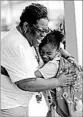  ?? DAVID J. PHILLIP/AP ?? School secretary Demitra Cain greets Danielle Outley, 7, for her first day of second grade on Monday.