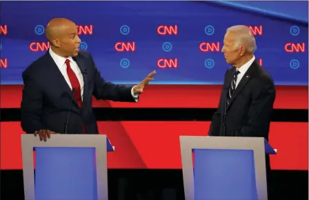  ?? PAUL SANCYA — THE ASSOCIATED PRESS ?? Sen. Cory Booker, D-N.J., gestures to former Vice President Joe Biden during the second of two Democratic presidenti­al primary debates hosted by CNN Wednesday, July 31, in the Fox Theatre in Detroit.