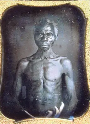  ?? JOHN SHISHMANIA­N/AP ?? Harvard biologist Louis Agassiz commission­ed this daguerreot­ype in 1850 of Renty, a slave whose image is at the center of a legal battle.