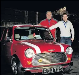  ??  ?? Proud Ramsay Stuart and co-driver Gary Smith with their 2001 Rover Mini