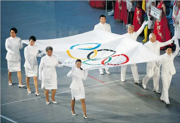  ?? — GETTY IMAGES ?? Nina Schultz’s grandmothe­r, Zheng Fengrong, third from left, was a world record holder for China in the high jump in 1957. She was named to help carry the flag into the stadium during the Opening Ceremony for the 2008 Beijing Summer Olympics.