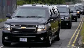  ??  ?? Security detail: Motorcade vehicles arrive at Prestwick Airport