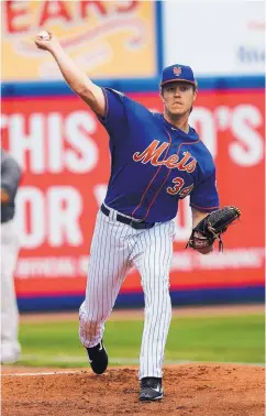  ?? JOHN BAZEMORE/ASSOCIATED PRESS ?? Mets pitcher Noah Syndergaar­d, shown warming up before a spring training game last week, threw 94 pitches at or over 100-plus mph last year.