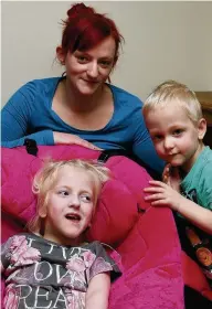  ??  ?? ●● Ellie with mum and younger brother Dexter. The youngster, who had cerebral palsy, died at home in her sleep