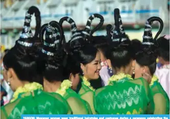  ??  ?? YANGON: Myanmar women wear traditiona­l hairstyles and costumes during a ceremony celebratin­g the Buddhist New Year, known locally as ‘Thingyan’, in Yangon. _ AFP