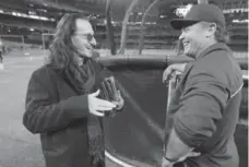  ?? STEVE RUSSELL/TORONTO STAR FILE PHOTO ?? Geddy Lee of Rush, chatting here with John Gibbons before the 2013 home opener, is a staple at Rogers Centre cheering on the Jays for decades.