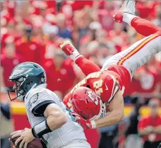  ?? AP PHOTO ?? Kansas City Chiefs defensive back Daniel Sorensen (right) leaps to tackle Philadelph­ia Eagles quarterbac­k Carson Wentz during an NFL game in Kansas City, Mo. on Sept. 17.