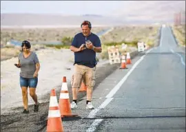  ?? Irfan Khan Los Angeles Times ?? MICHELLE AND GARY BINION of Rancho Cucamonga visit Searles Valley this month to examine how the twin earthquake­s of July 4 and 5 ruptured roads.