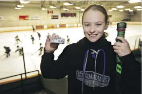  ?? DAVID BLOOM ?? Riley Scorgie, 11, holds the puck she put in the net Friday to score her 50th goal for the Ice Guardians. Riley, diagnosed with Guillain-Barre syndrome in the fall, was determined to get back on her skates.