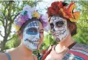  ?? DAVID KADLUBOWSK­I/THE REPUBLIC ?? Alia Mougharbel (left) and Dana Bennewitz take part in a past Dia de los Muertos Festival at the Mesa Arts Center.