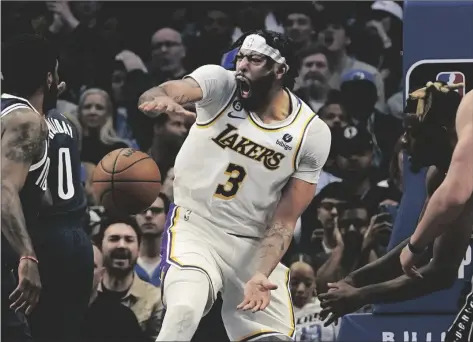  ?? AP PHOTO/LM OTERO ?? Los Angeles Lakers forward Anthony Davis (3) reacts after scoring on a slam dunk against the Dallas Mavericks during the fourth quarter of an NBA basketball game in Dallas, on Sunday.