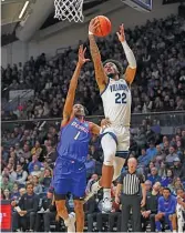  ?? GETTY IMAGES ?? Villanova’s Cam Whitmore shoots the ball against DePaul’s Javan Johnson on Wednesday night. Johnson had 18 points in the loss.