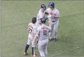  ?? Canadian Press photo ?? Houston Astros' Carlos Correa, top left, is congratula­ted by Jose Altuve (27) Evan Gattis (11) and Norichika Aoki after hitting three-run home run against the Toronto Blue Jays during seventh inning American League MLB baseball action in Toronto on...