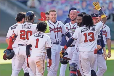  ?? Ap-john Bazemore ?? The Atlanta Braves’ Freddie Freeman (5) celebrates driving in the game-winning run against the Cincinnati Reds in the 13th inning during Game 1 of a National League wild-card baseball series, Wednesday in Atlanta. The Atlanta Braves won 1-0.