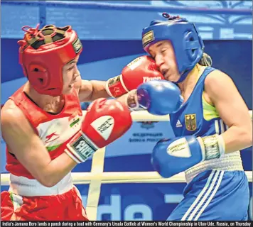  ??  ?? India's Jamuna Boro lands a punch during a bout with Germany's Ursula Gottlob at Women's World Championsh­ip in Ulan-Ude, Russia, on Thursday