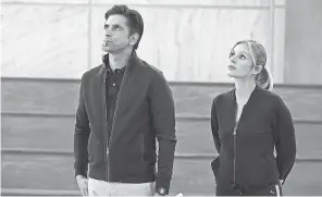  ??  ?? John Stamos and Jessalyn Gilsig star in the new Disney+ series “Big Shot.” PROVIDED BY GILLES MINGASSON/ DISNEY+