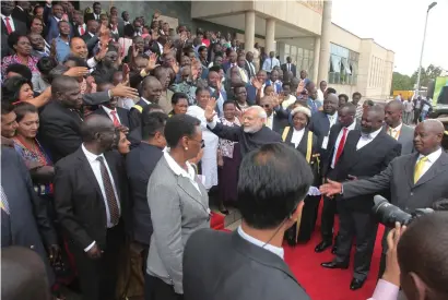  ?? AP ?? Indian Prime Minister Narendra Modi waves to Uganda Members of Parliament as Uganda President Yoweri Museveni, right, looks on in the Uganda capital Kampala on Wednesday. —